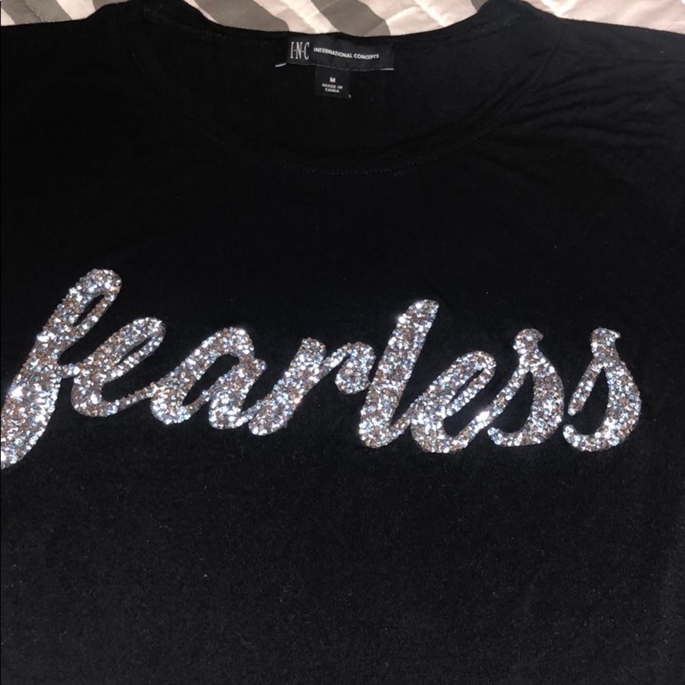 Black top with sparkly lettering “Fearless”